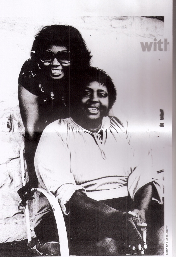 Black and white photo of Fontella Bass leaning over her seated mother Martha, both smiling, accompanies interview